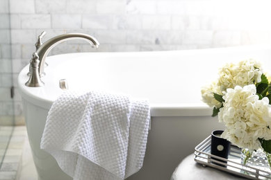 Example of a mid-sized transitional master white tile and marble tile marble floor and white floor freestanding bathtub design in Sacramento with shaker cabinets, white cabinets, gray walls, an undermount sink, marble countertops, a hinged shower door and white countertops