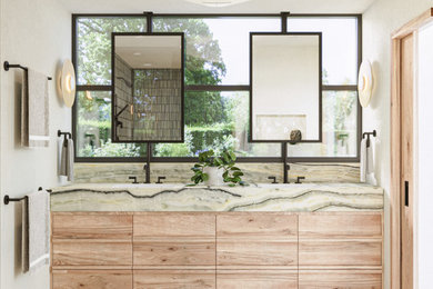 Inspiration for a large scandinavian master green tile and ceramic tile limestone floor, white floor and double-sink bathroom remodel in Los Angeles with furniture-like cabinets, light wood cabinets, a wall-mount toilet, white walls, an undermount sink, onyx countertops, green countertops, a niche and a floating vanity