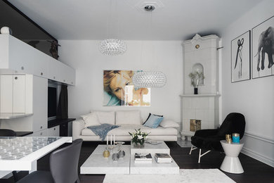 This is an example of a mid-sized modern formal enclosed living room in Stockholm with white walls, dark hardwood floors, no fireplace and no tv.