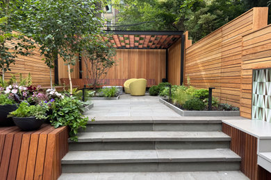 Patio - mid-sized contemporary backyard stone patio idea in New York with a pergola