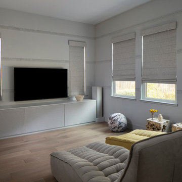 Home theater with custom TV component cabinet and wall trim