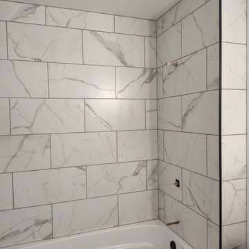 Custom Tile Tub Surround with Black Herringbone Mosaics