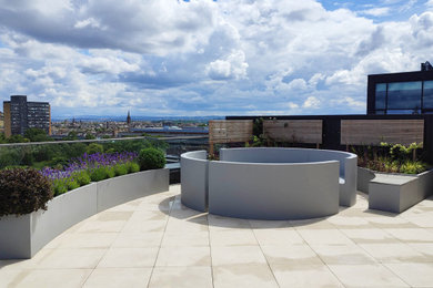 Design ideas for a roof rooftop terrace in Edinburgh with a fire feature.