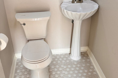 Small french country porcelain tile, gray floor and single-sink bathroom photo in Oklahoma City with white cabinets, a two-piece toilet and a freestanding vanity