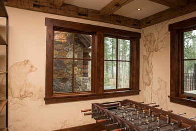 Huge mountain style enclosed medium tone wood floor game room photo in Other with beige walls, no fireplace and no tv