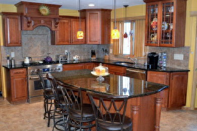 Kitchen - large traditional l-shaped ceramic tile and beige floor kitchen idea in New York with an undermount sink, raised-panel cabinets, medium tone wood cabinets, granite countertops, multicolored backsplash, porcelain backsplash, stainless steel appliances and an island