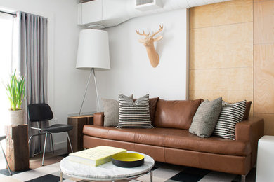 Inspiration for an industrial living room in Toronto with white walls.