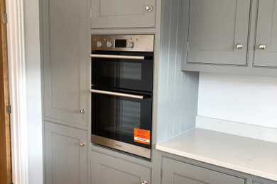 Design ideas for a traditional kitchen in Other with shaker cabinets, quartz worktops and an island.