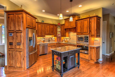 Kitchen - rustic kitchen idea in Other with raised-panel cabinets, granite countertops, subway tile backsplash and an island