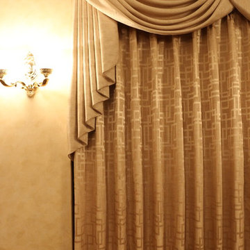 Swags overlaying pinch pleated curtains