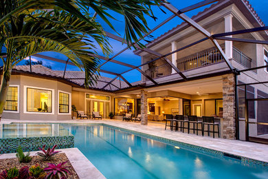 Hot tub - large mediterranean backyard concrete paver and rectangular lap hot tub idea in Tampa