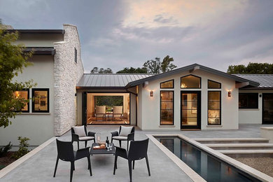 Large contemporary white two-story stucco exterior home idea in San Francisco with a metal roof