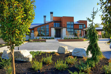 Example of a huge minimalist multicolored three-story mixed siding house exterior design in Indianapolis with a metal roof