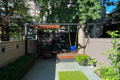 Design ideas for a mid-sized modern shade backyard stone landscaping in New York.