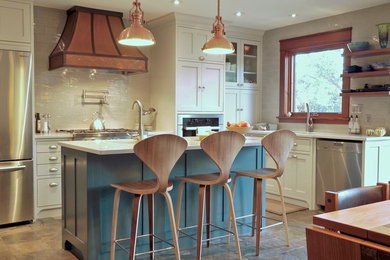 Open concept kitchen - traditional l-shaped ceramic tile and brown floor open concept kitchen idea in Calgary with an undermount sink, beaded inset cabinets, quartz countertops, white backsplash, subway tile backsplash, stainless steel appliances and an island