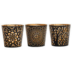 MarktSq - Set of 3 Metal Tealight Candle Holders in Black and Gold - Set of three metal tealight candle holders featuring a striking laser cut design. When lit the design creates a serene shadow that instantly makes the room cozy and inviting. The candle holders come in a black and gold color combination. These candle holders are perfect for all occasions and can be used in any room. All three tealight candle holders are different and can be used as a combination or in separate areas.