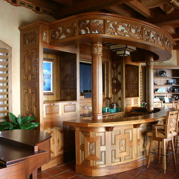 Spanish-revival bar, bar stools, lamps, and glasswork