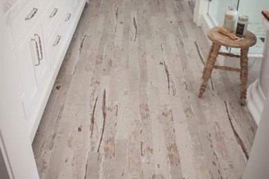 Example of a mid-sized beach style master white tile and subway tile vinyl floor and brown floor bathroom design in San Diego with raised-panel cabinets, white cabinets, white walls, a vessel sink, marble countertops and a hinged shower door