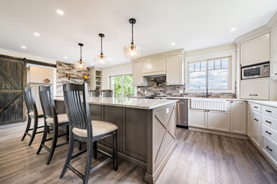 Country vinyl floor eat-in kitchen photo in Toronto with a farmhouse sink, quartz countertops, porcelain backsplash and an island
