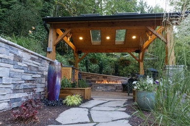 Photo of a craftsman stone landscaping in Other with a pergola.