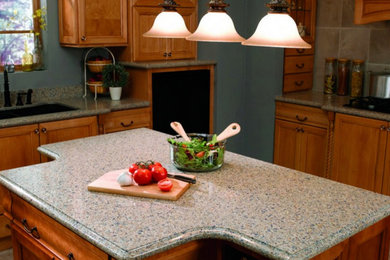 Mid-sized elegant l-shaped kitchen photo in Los Angeles with a single-bowl sink, recessed-panel cabinets, medium tone wood cabinets, quartz countertops, beige backsplash, ceramic backsplash, an island and paneled appliances