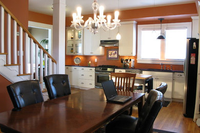 Kitchen/dining room combo - contemporary medium tone wood floor kitchen/dining room combo idea in Atlanta with orange walls