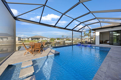 Example of a large trendy backyard custom-shaped pool design in Other