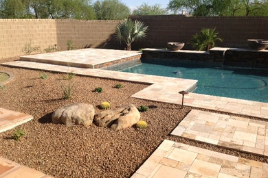Hot tub - large southwestern backyard stone and custom-shaped natural hot tub idea in Phoenix