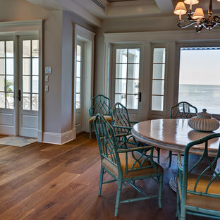 Inspiration for a mid-sized arts and crafts open plan dining in Miami with medium hardwood floors, grey walls, no fireplace and brown floor.