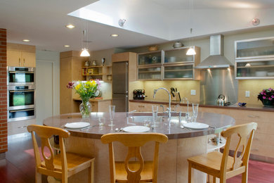 Example of a large minimalist l-shaped eat-in kitchen design in Boston with an island
