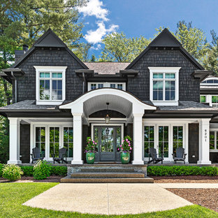 Large beach style black two-story wood exterior home photo in Detroit with a shingle roof