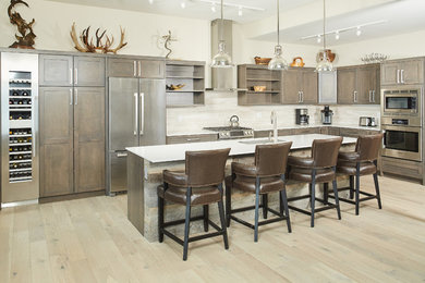 L-shaped kitchen photo in Other with beige backsplash, stone tile backsplash and an island