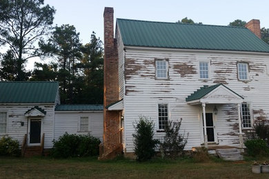 Example of a large arts and crafts white two-story wood exterior home design in Raleigh with a metal roof