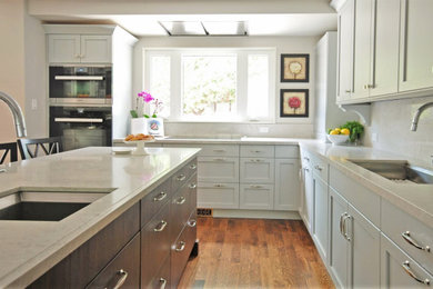 Mid-sized transitional l-shaped medium tone wood floor open concept kitchen photo in Other with an undermount sink, recessed-panel cabinets, blue cabinets, quartz countertops, white backsplash, quartz backsplash, an island and white countertops