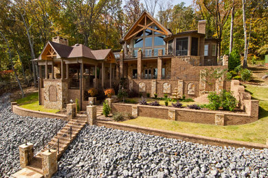 Inspiration for a large timeless brown two-story mixed siding house exterior remodel in Other with a hip roof and a shingle roof