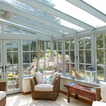 Timber framed lean-to conservatory on a traditional Sussex flint house