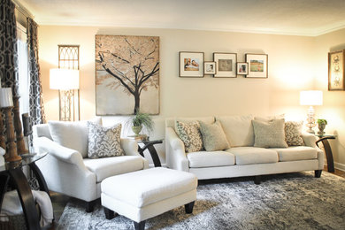 Example of a mid-sized classic enclosed medium tone wood floor living room design in Raleigh with beige walls, no fireplace and no tv