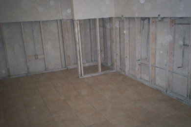 Huge minimalist walk-out porcelain tile basement photo in Milwaukee with white walls