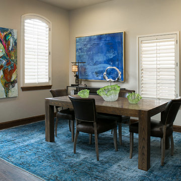 Dining Room With Dark Wood Table and Oil Paintings