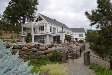 Large elegant beige two-story wood gable roof photo in Seattle