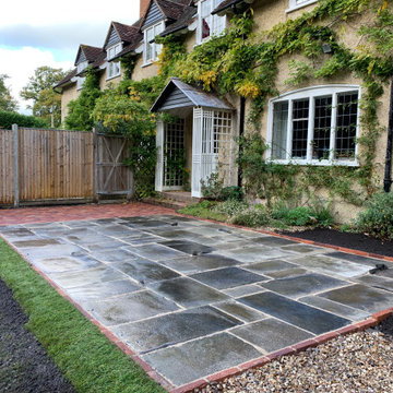 Reclaimed Yorkstone terrace with herringbone brick path