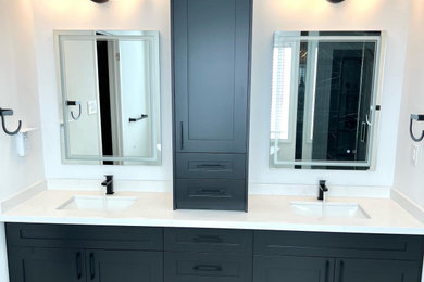 Bathroom - white tile double-sink bathroom idea in Toronto with shaker cabinets, black cabinets, an undermount sink, wood countertops and white countertops