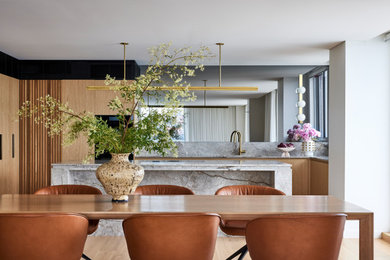 Design ideas for a contemporary u-shaped kitchen in Sydney with an undermount sink, flat-panel cabinets, medium wood cabinets, grey splashback, stone slab splashback, light hardwood floors, with island, beige floor and grey benchtop.