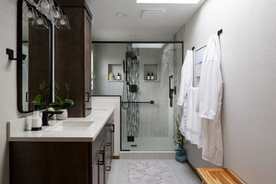 На фото: большая ванная комната в современном стиле с фасадами в стиле шейкер, темными деревянными фасадами, двойным душем, раздельным унитазом, разноцветной плиткой, керамогранитной плиткой, серыми стенами, полом из керамогранита, врезной раковиной, столешницей из искусственного кварца, серым полом, душем с распашными дверями, белой столешницей, нишей, тумбой под две раковины и встроенной тумбой с