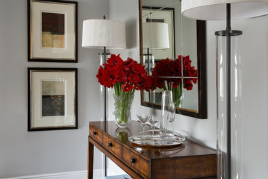 Entryway - small transitional dark wood floor entryway idea in New York with gray walls and a gray front door