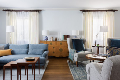 Living room - large traditional open concept brown floor and dark wood floor living room idea in Los Angeles with white walls, a standard fireplace, a brick fireplace and a tv stand