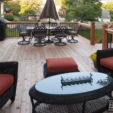Leeder - Cedar deck in Kansas City with stamped concrete patio and firepit.