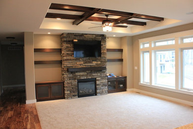 Living room - large rustic enclosed medium tone wood floor and brown floor living room idea in Cedar Rapids with beige walls, a standard fireplace, a stone fireplace and a wall-mounted tv