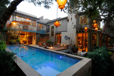 Inspiration for a modern backyard concrete paver and rectangular lap pool remodel in Los Angeles