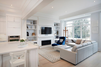 Example of a transitional medium tone wood floor family room design in Toronto with white walls, a ribbon fireplace and a wall-mounted tv